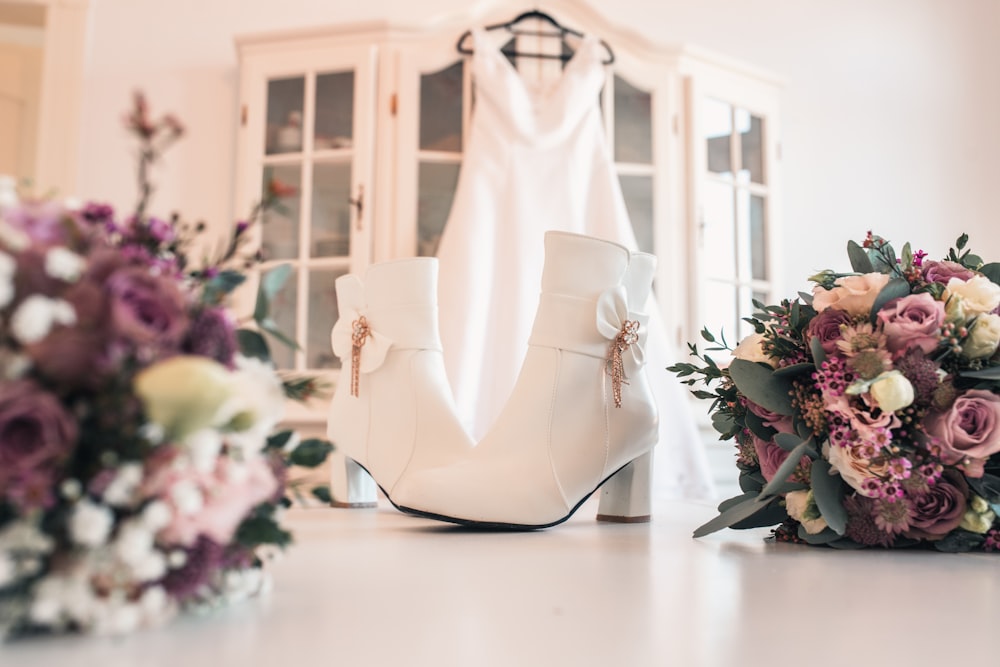 a bouquet of flowers and a pair of white shoes