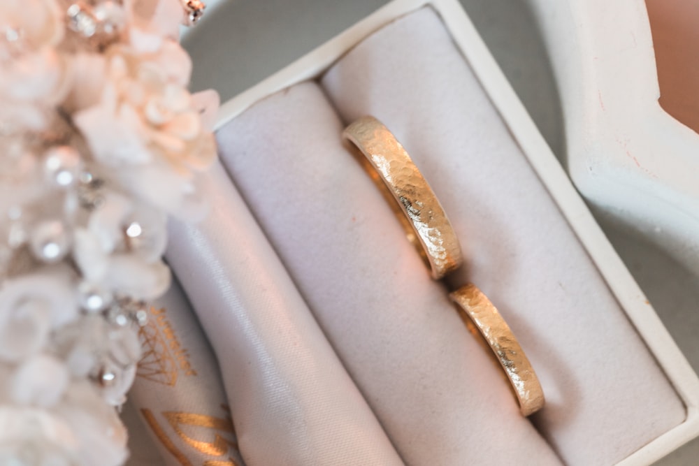 a couple of wedding rings sitting in a box