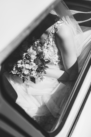 Une femme en robe de mariage avec un bouquet de fleurs