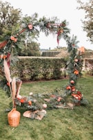 A vibrant floral archway at an outdoor wedding.