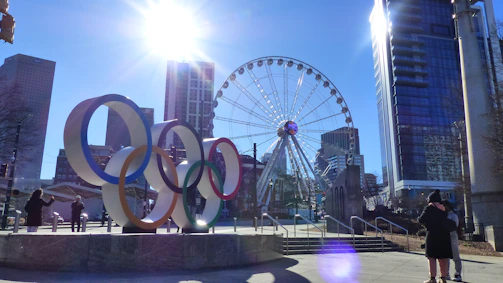Group enjoying giant olympiads games outdoors in daylight.