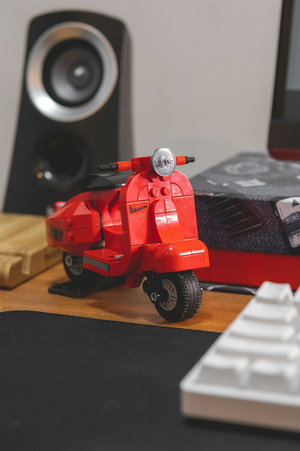 a red toy motorcycle sitting on top of a desk