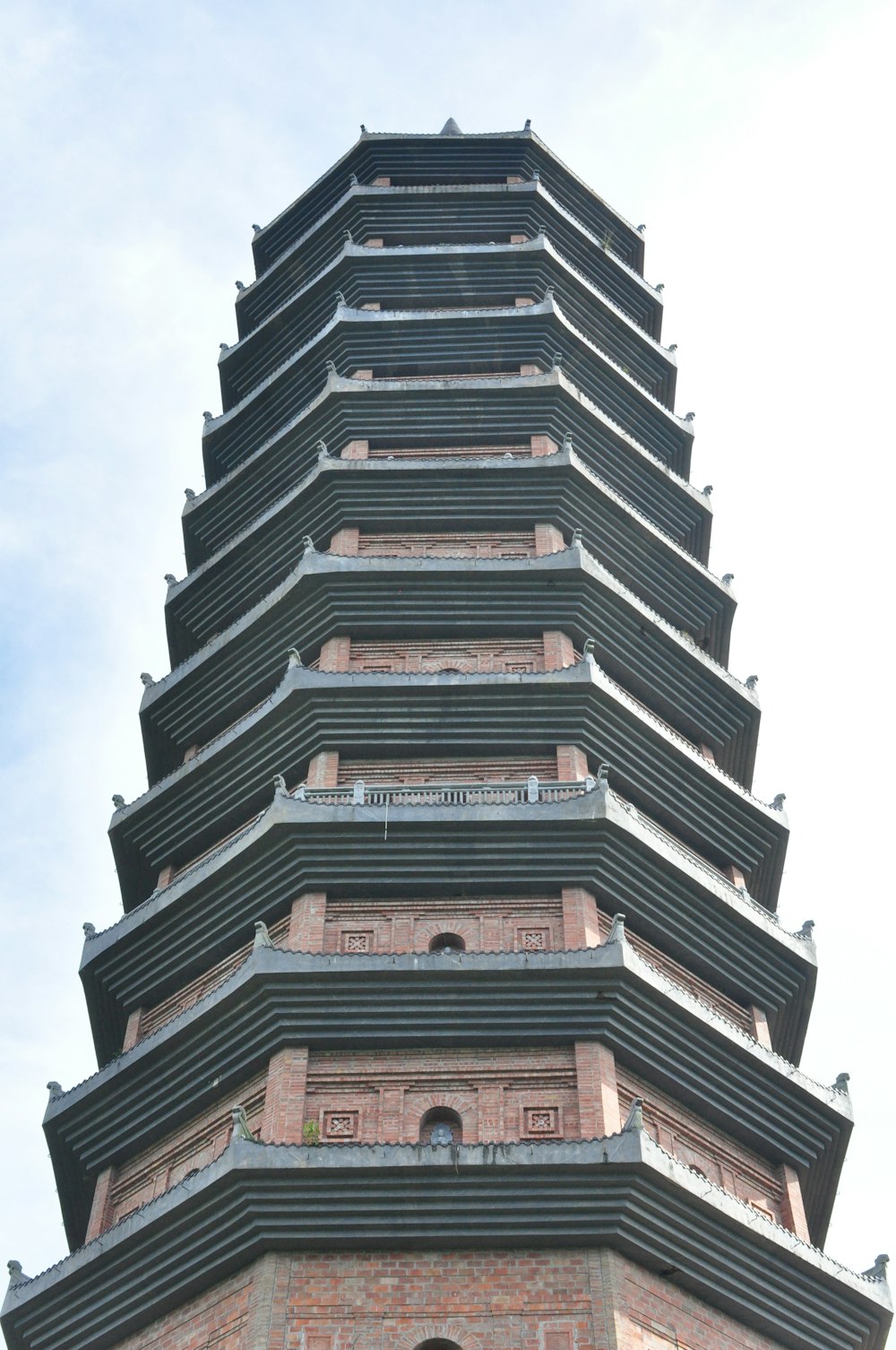 a tall brick tower with a clock on it's side