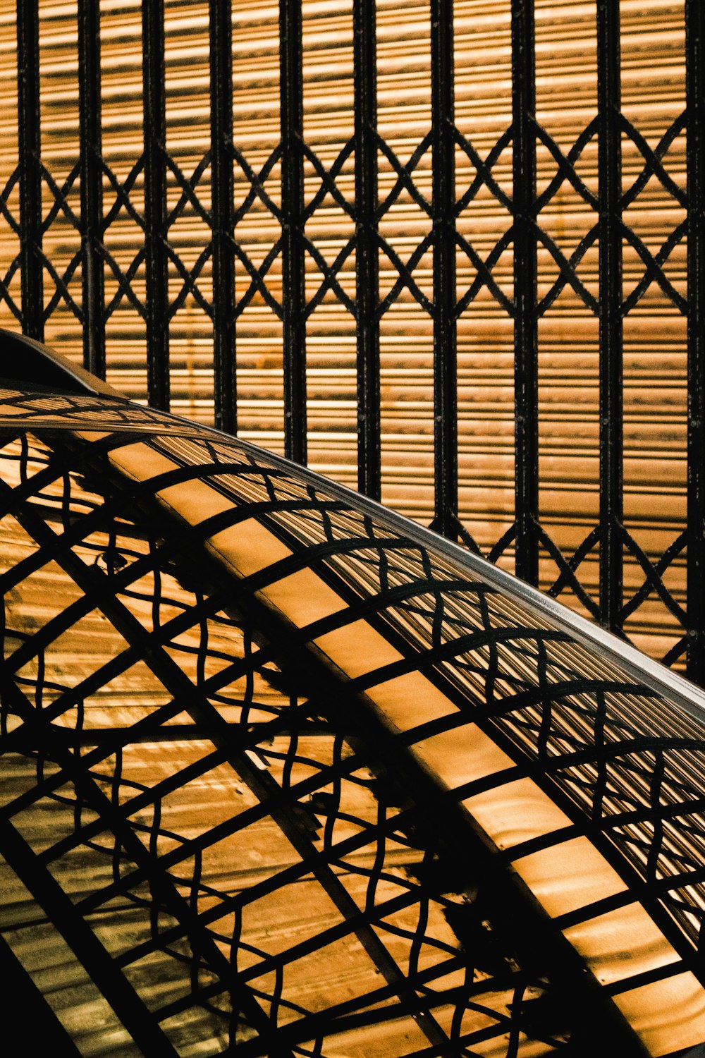 a close up of a metal structure with wood slats