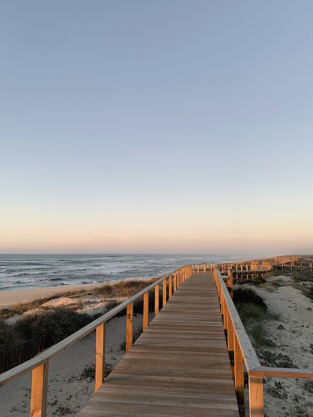 a wooden walkway leading to the beach