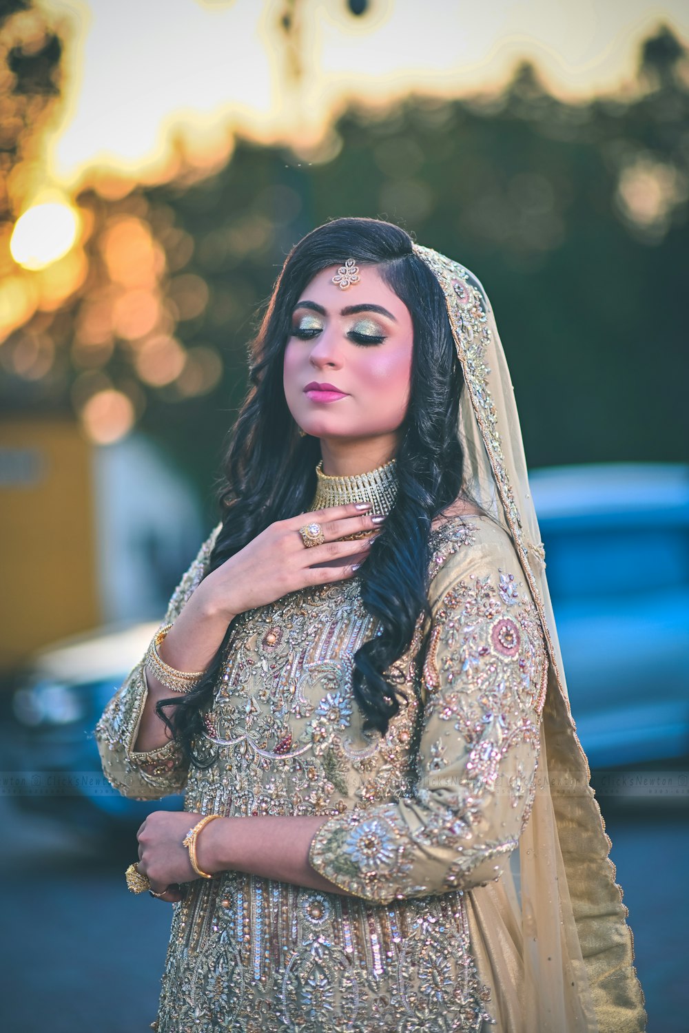 a woman in a bridal outfit poses for a picture