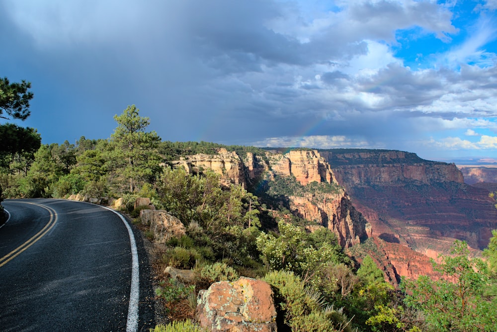 a scenic view of the grand canyon with a rainbow in the sky