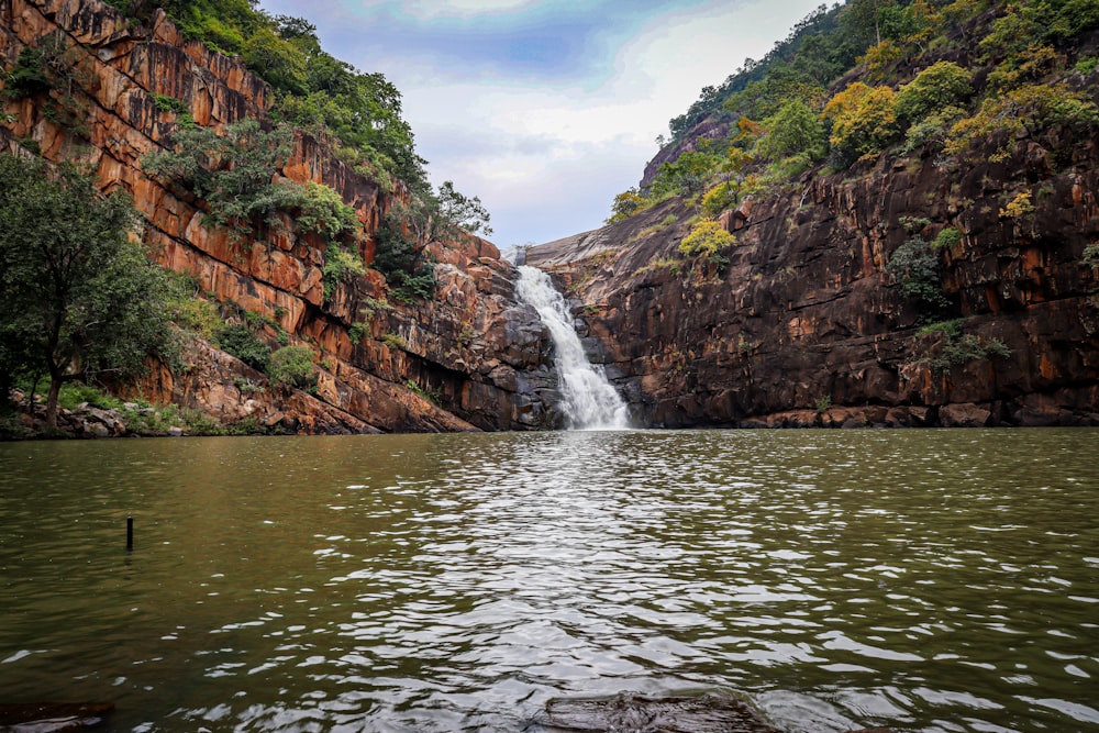 a large waterfall in the middle of a body of water