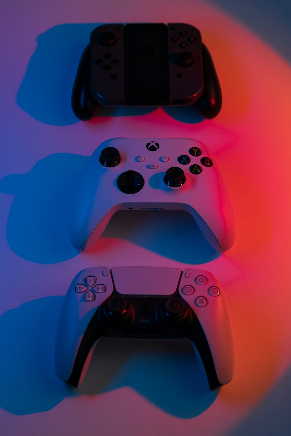 two video game controllers sitting next to each other