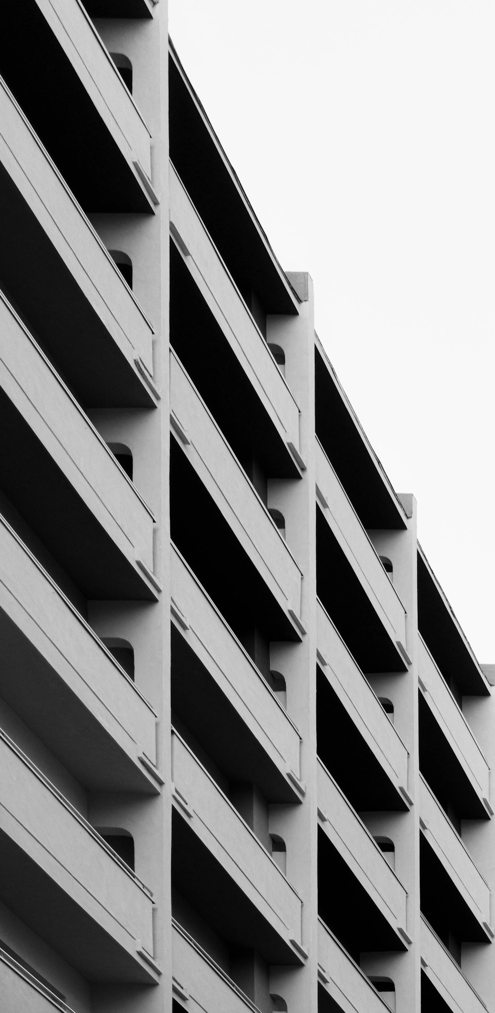 a black and white photo of a building with balconies