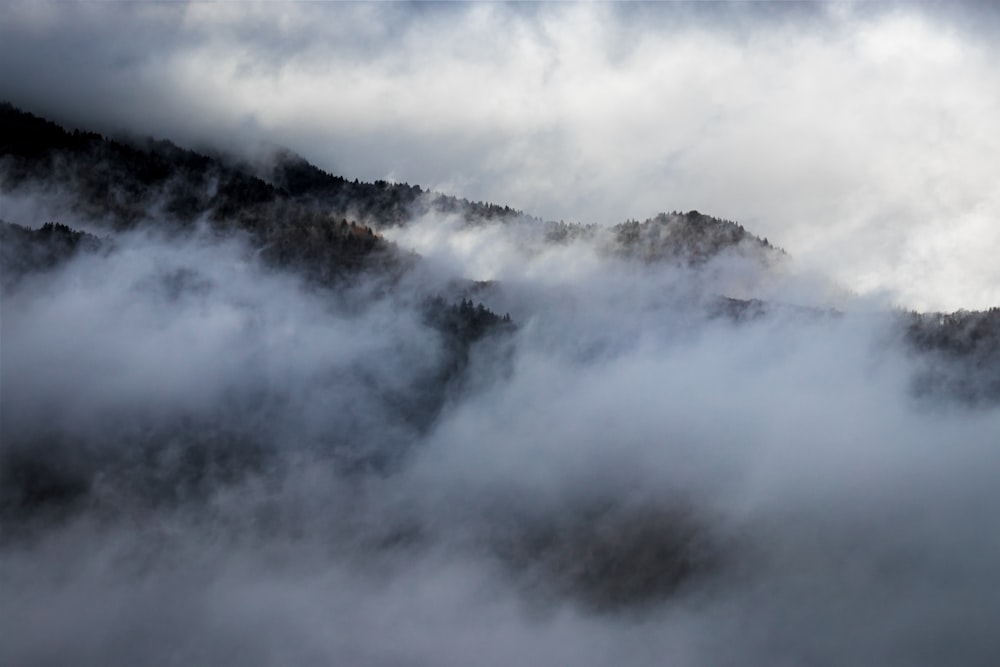 a view of a mountain covered in clouds