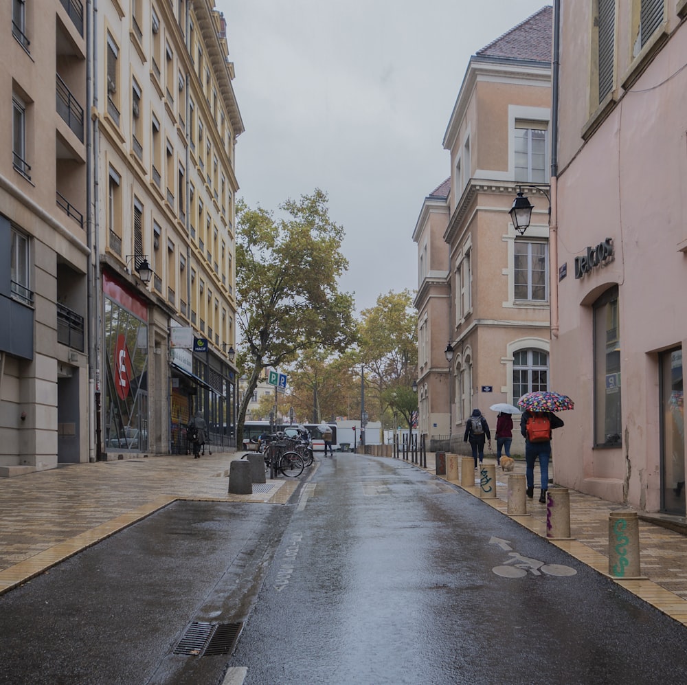 people walking down a street in the rain