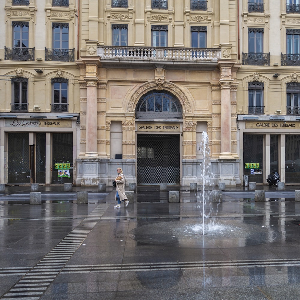 a large building with a fountain in front of it