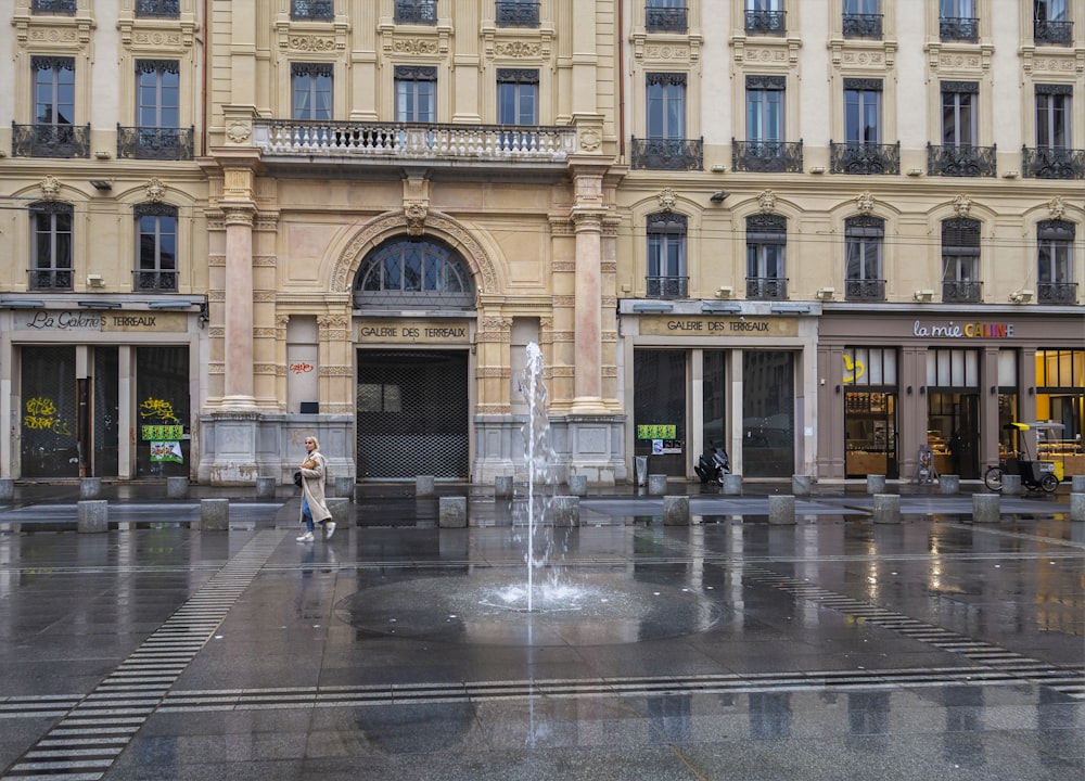 a large building with a fountain in front of it