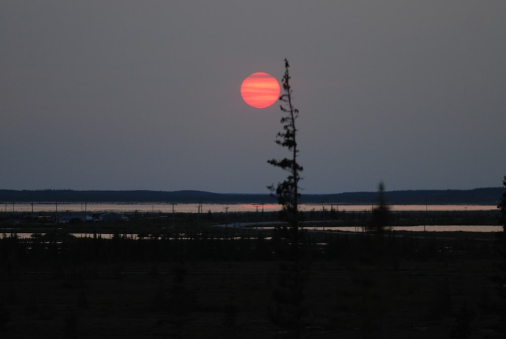 the sun is setting in the distance over the water