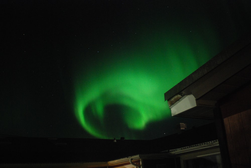 a bright green aurora bore in the night sky