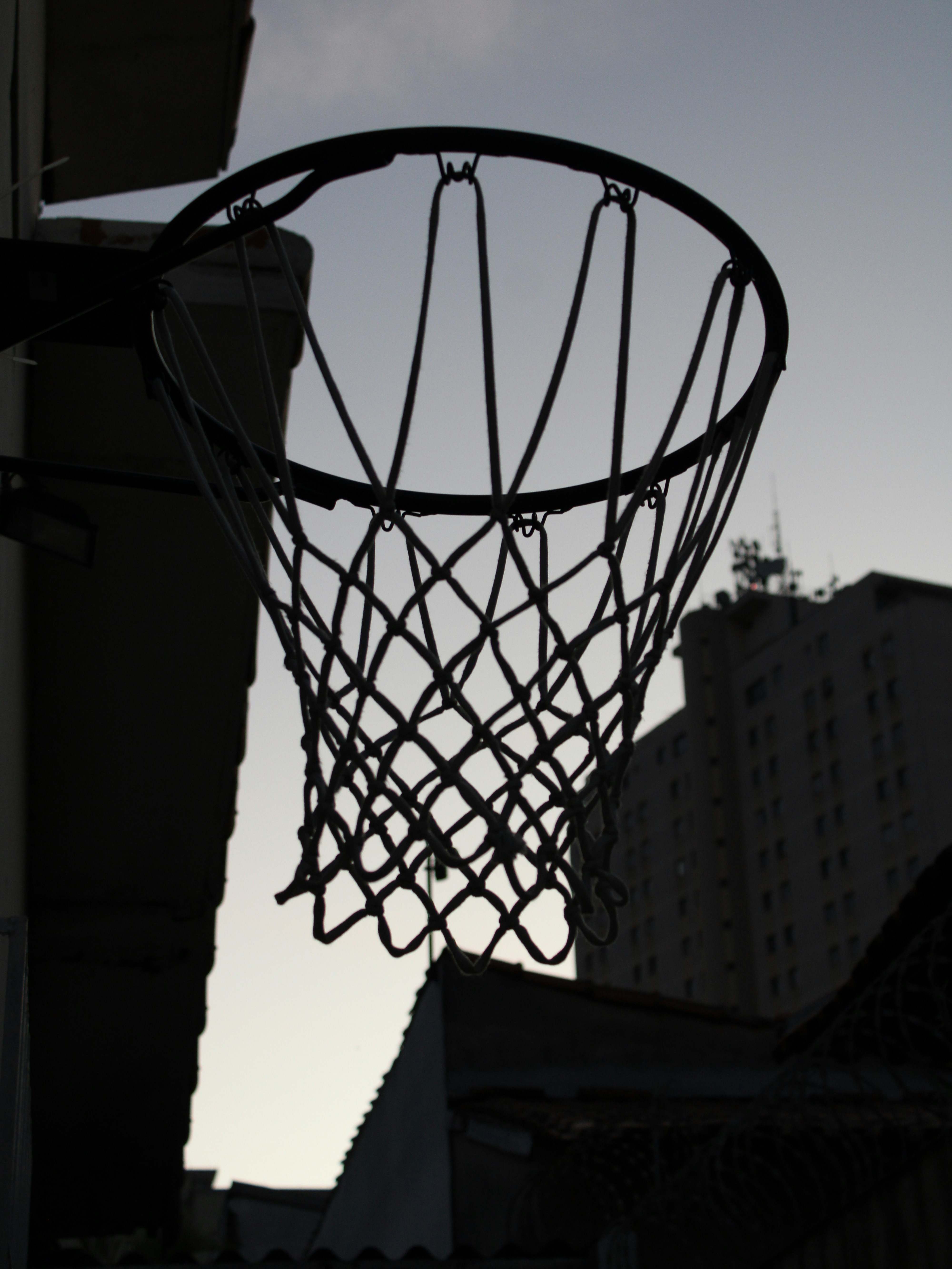 a basketball hoop hanging from the side of a building