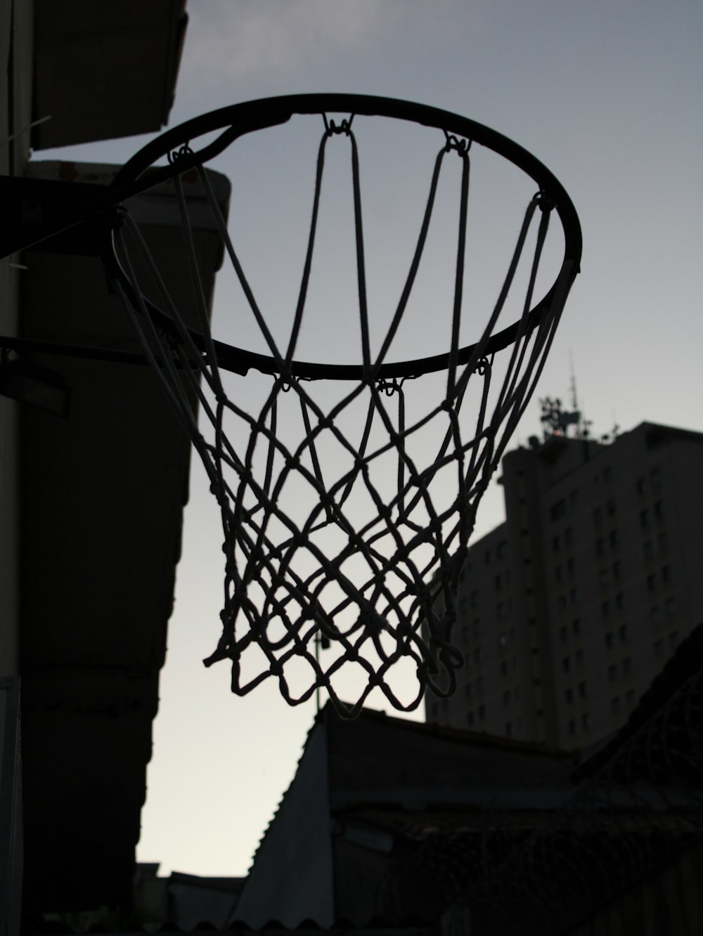 a basketball hoop hanging from the side of a building