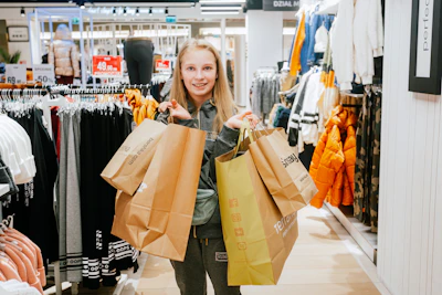 a woman holding shopping bags in a store