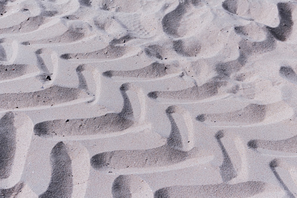 a close up of a tire tread in the sand
