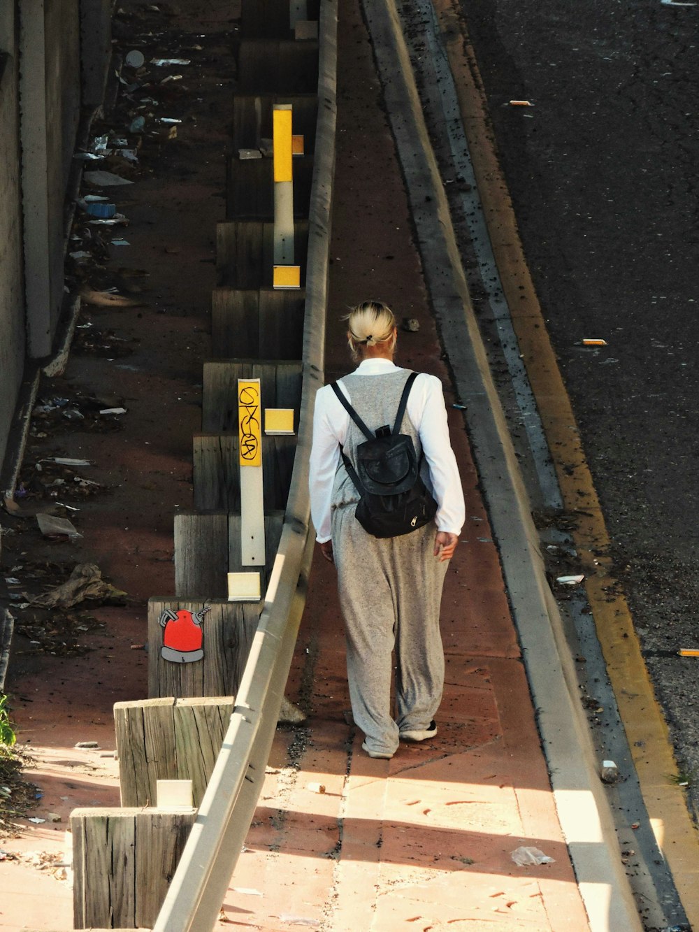a person with a backpack walking up some stairs