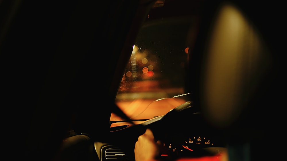 a view of the dashboard of a car at night