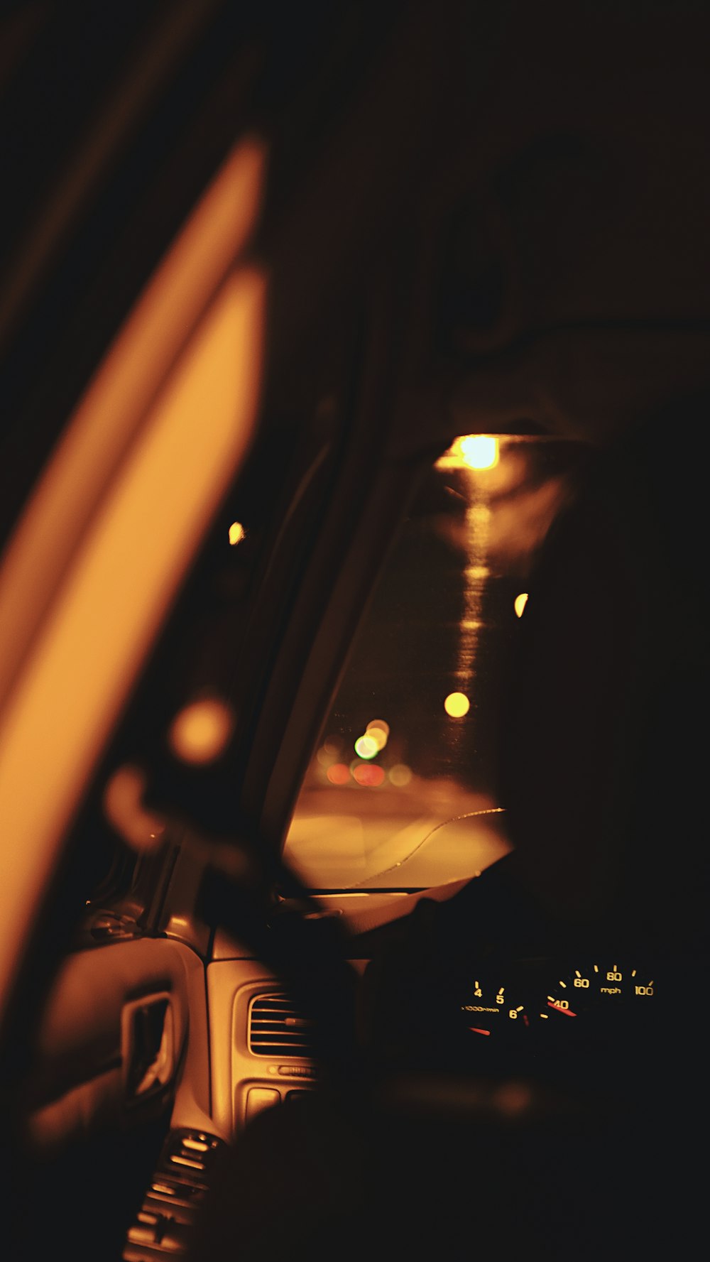 a view from inside a car of a street at night