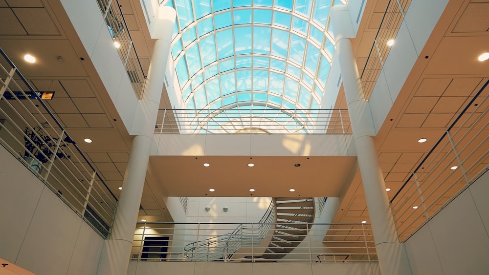 a large atrium with a spiral staircase and a skylight