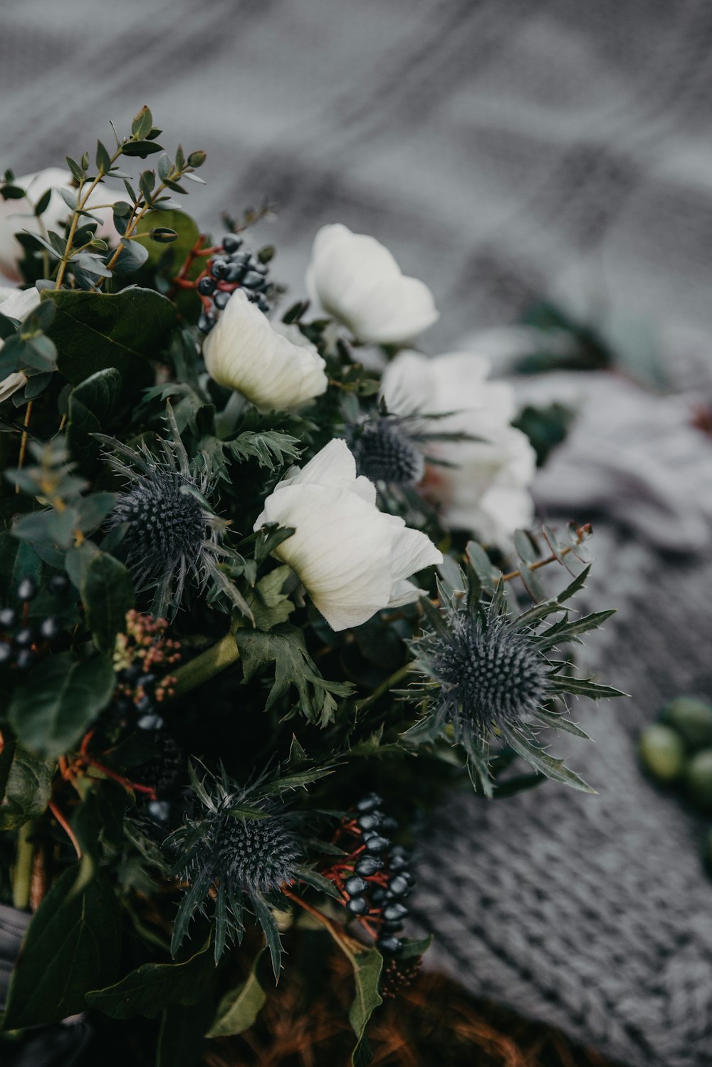 a bouquet of white flowers sitting on top of a blanket