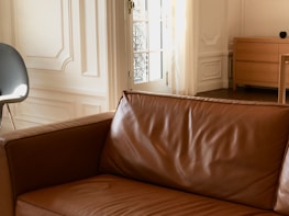 Polished wooden sofa frame shining under warm light in a home setting.