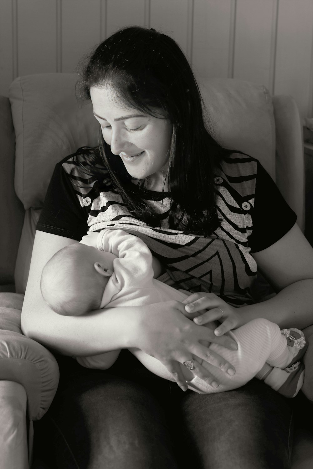 a woman holding a baby in her arms