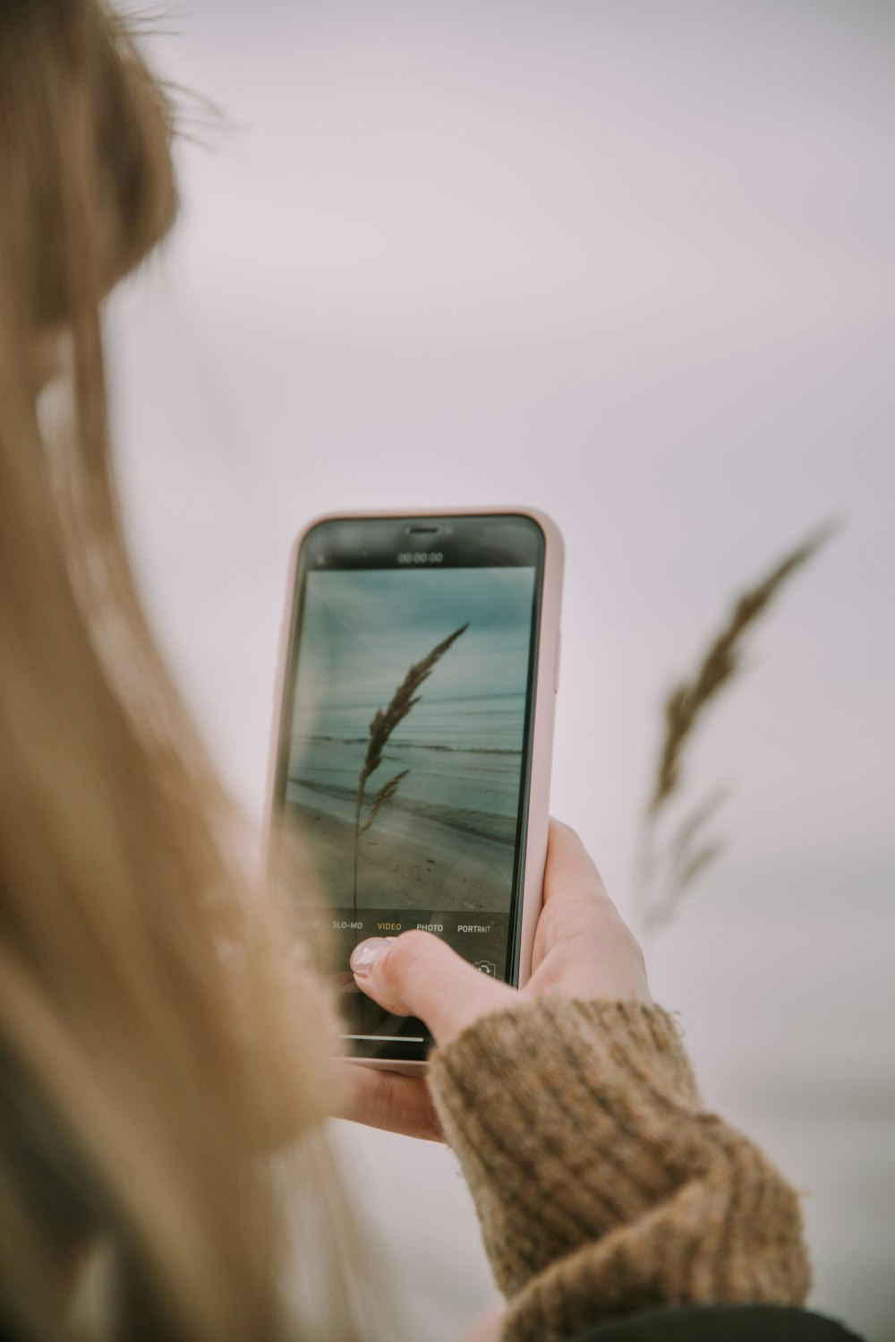 a woman holding a cell phone in her hand