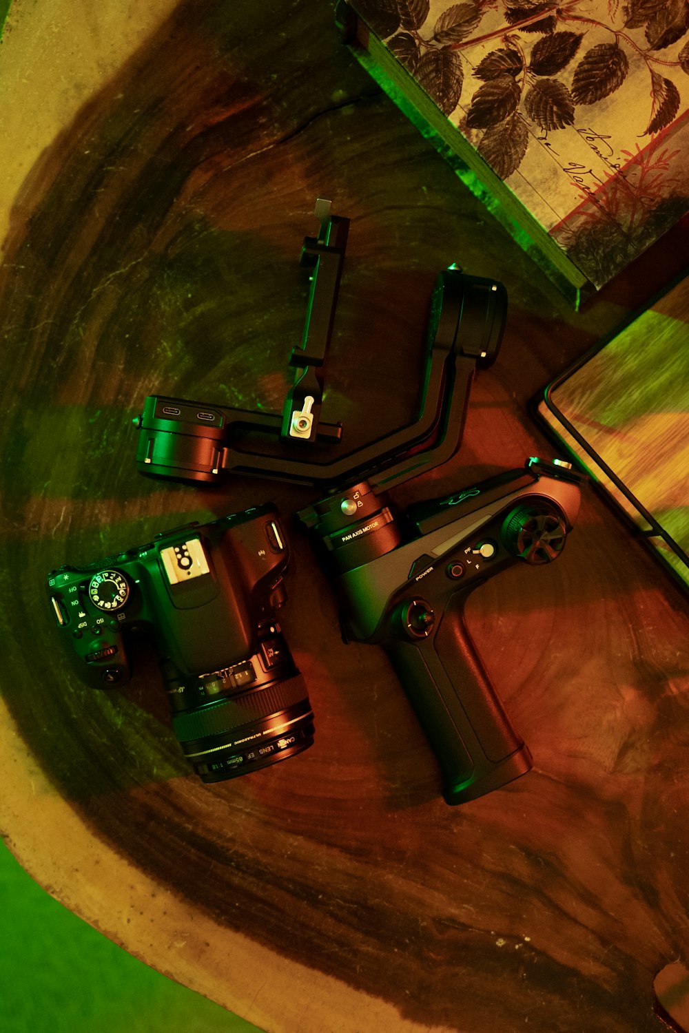 a group of cameras sitting on top of a wooden table
