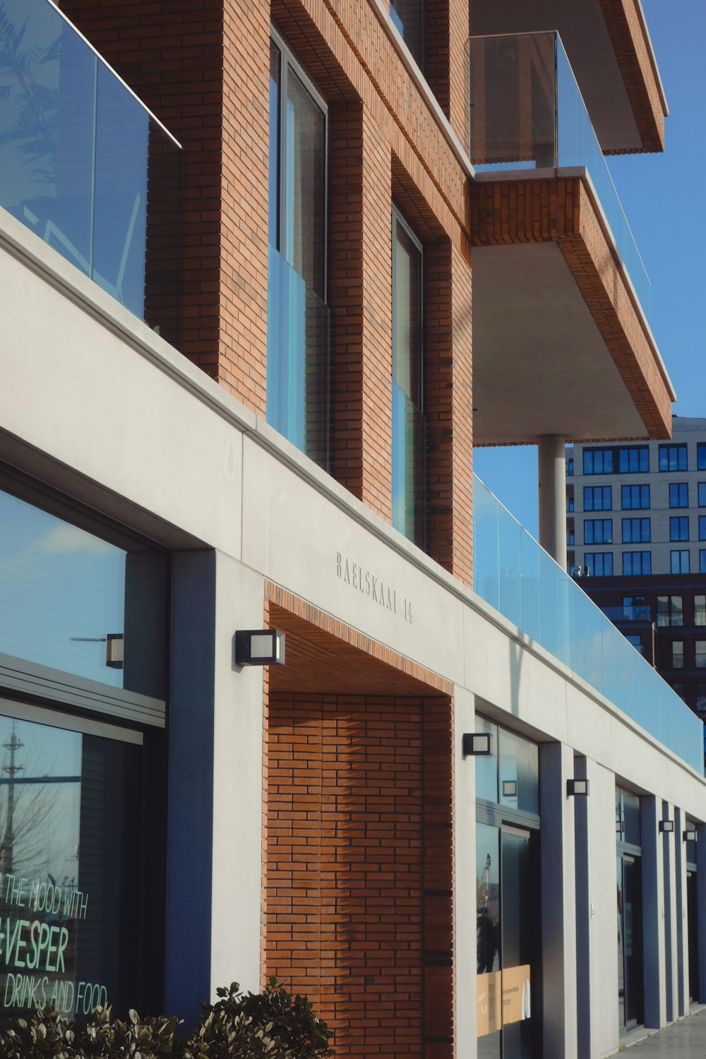 a brick building with a glass balcony and balconies