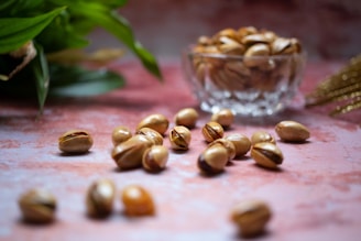 a glass bowl filled with nuts on top of a table
