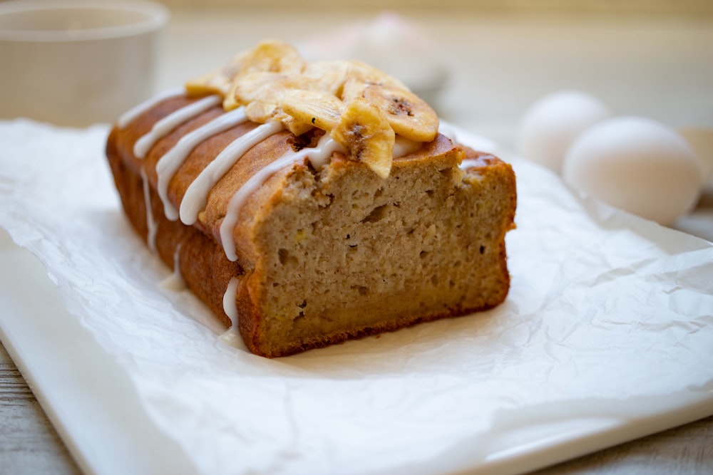 a loaf of banana bread sitting on top of a white napkin