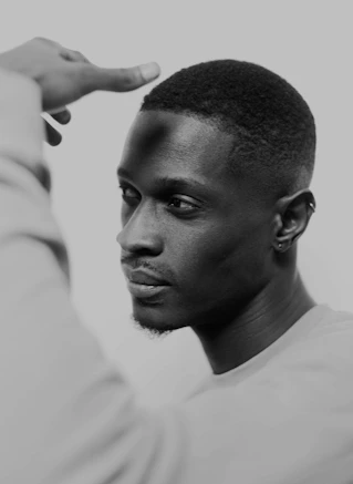 a man is holding his hand up to his head