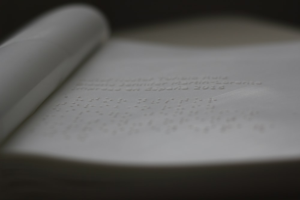 a close up of an open book with writing on it