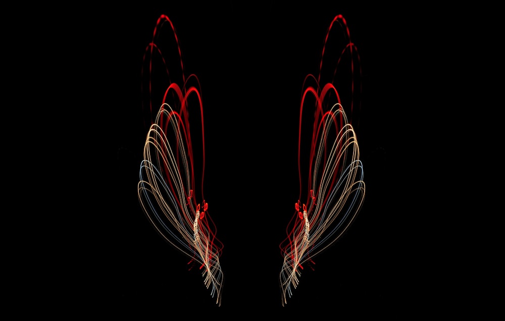 a pair of red and white wings on a black background