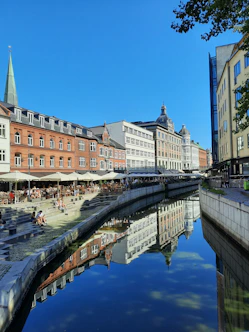 a river running through a city next to tall buildings