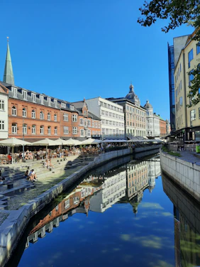a river running through a city next to tall buildings