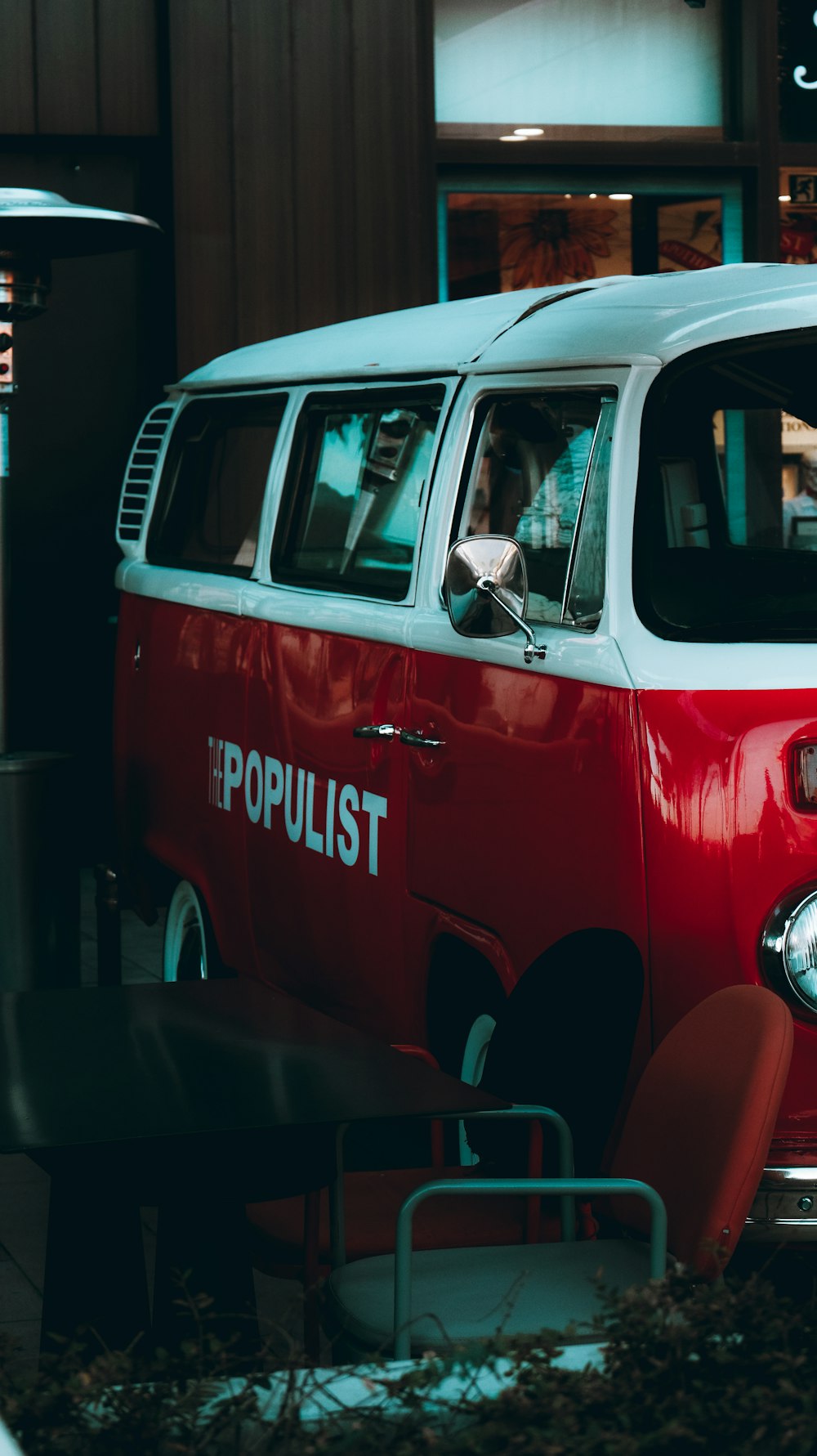 a red and white van parked in front of a building