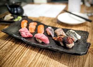 Fresh sushi artfully arranged on a wooden platter at a small Tokyo eatery