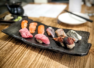 Fresh sushi artfully arranged on a wooden platter at a small Tokyo eatery