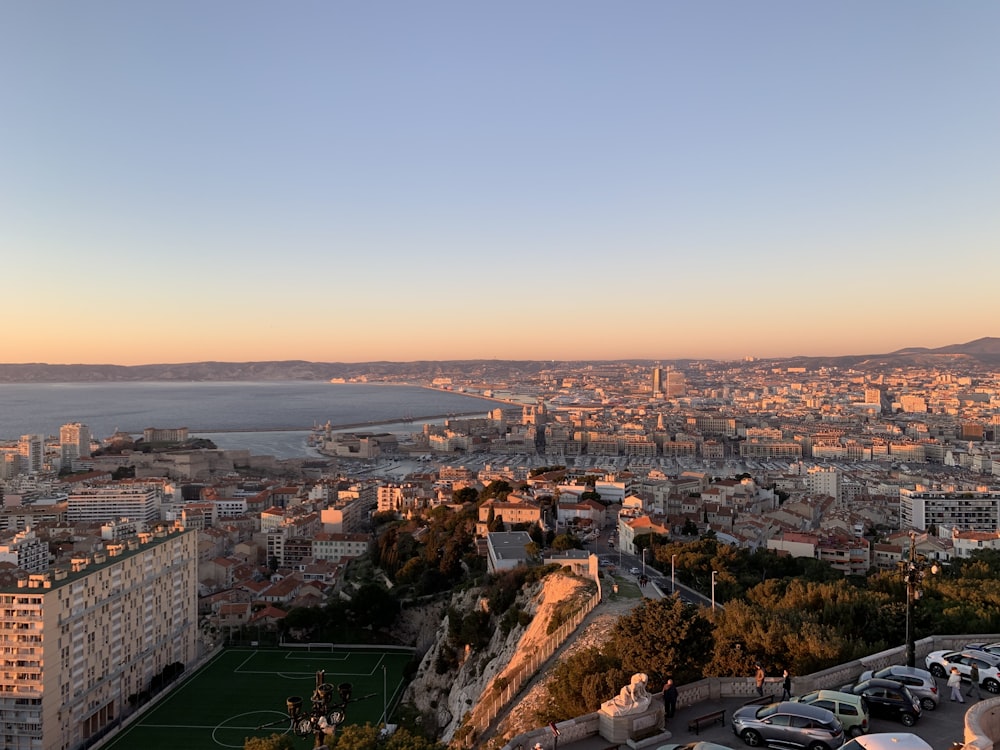 a view of a city with a soccer field in the foreground