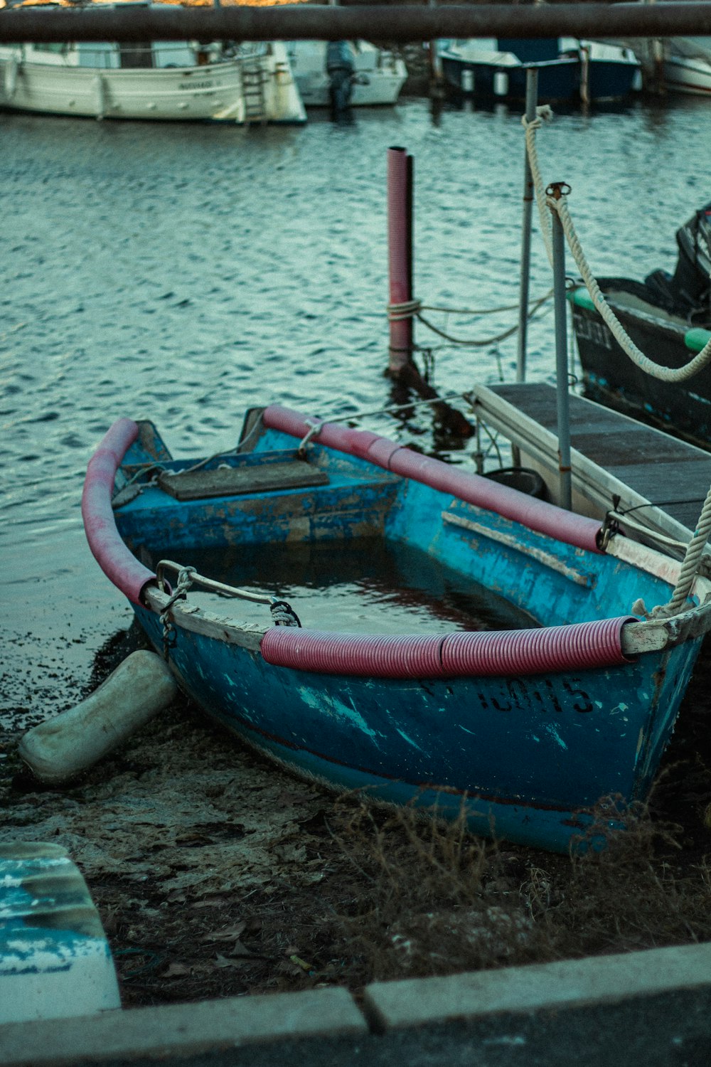 a blue boat sitting on top of a body of water