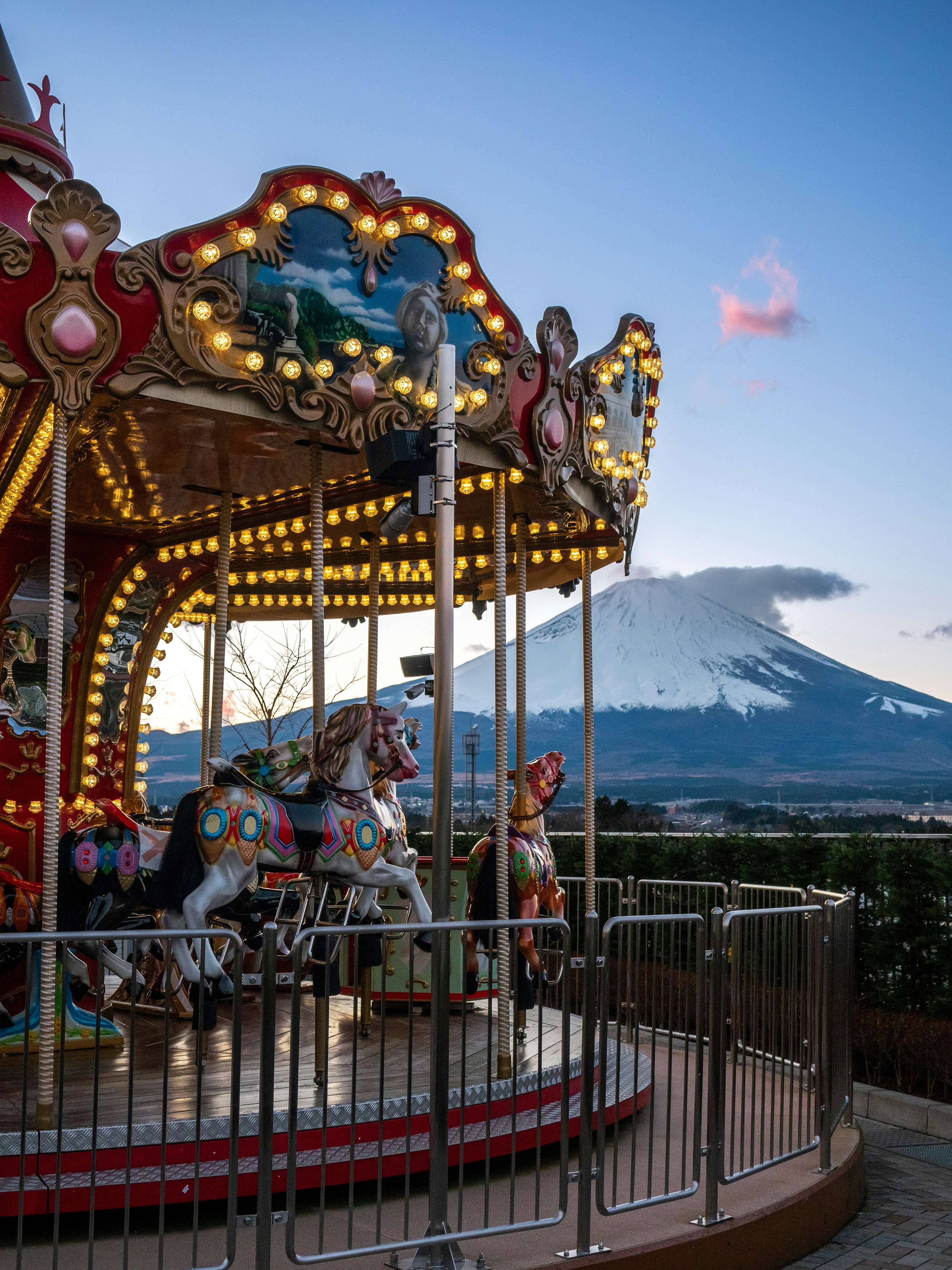 a merry go round with a mountain in the background