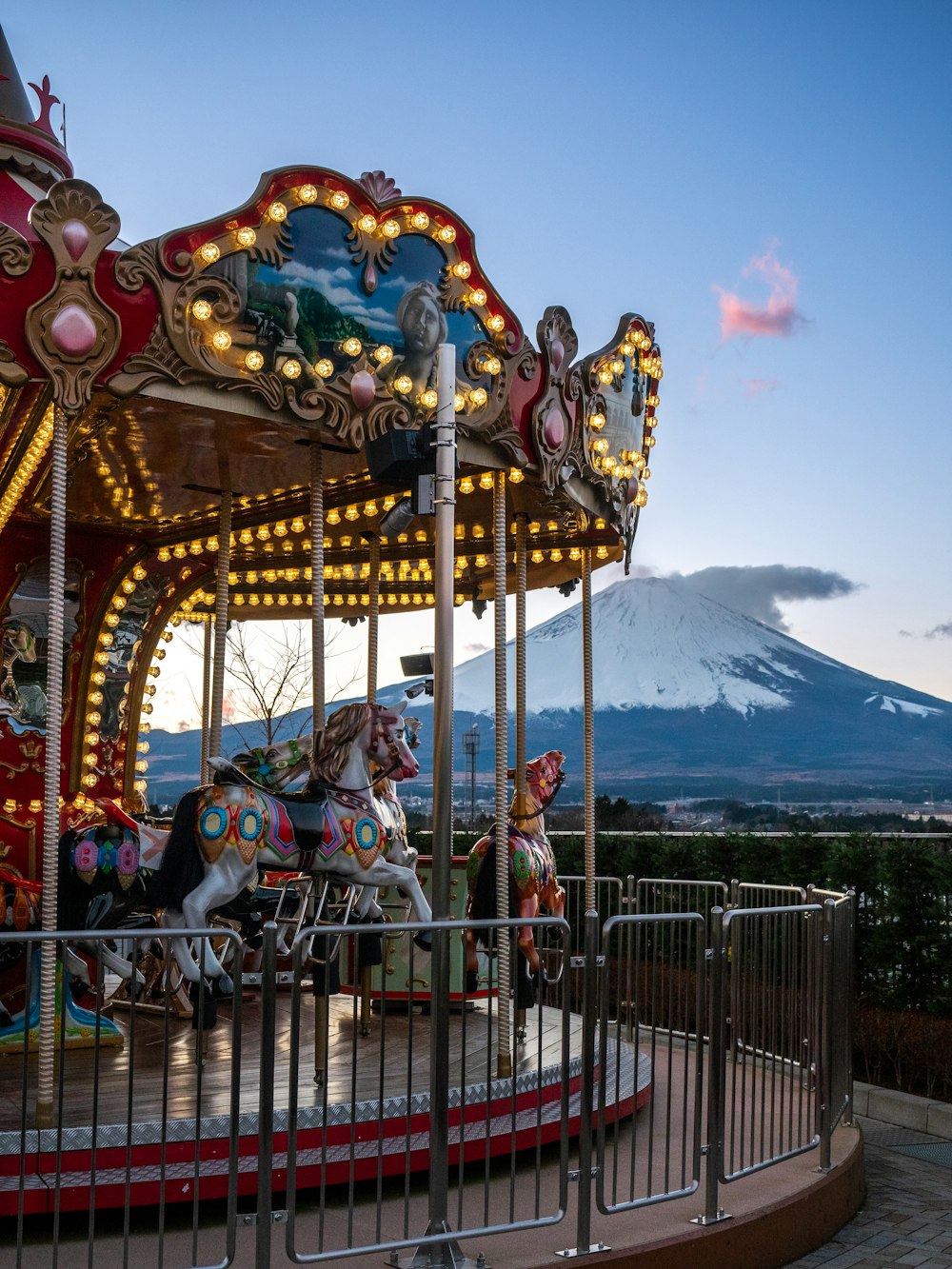 a merry go round with a mountain in the background