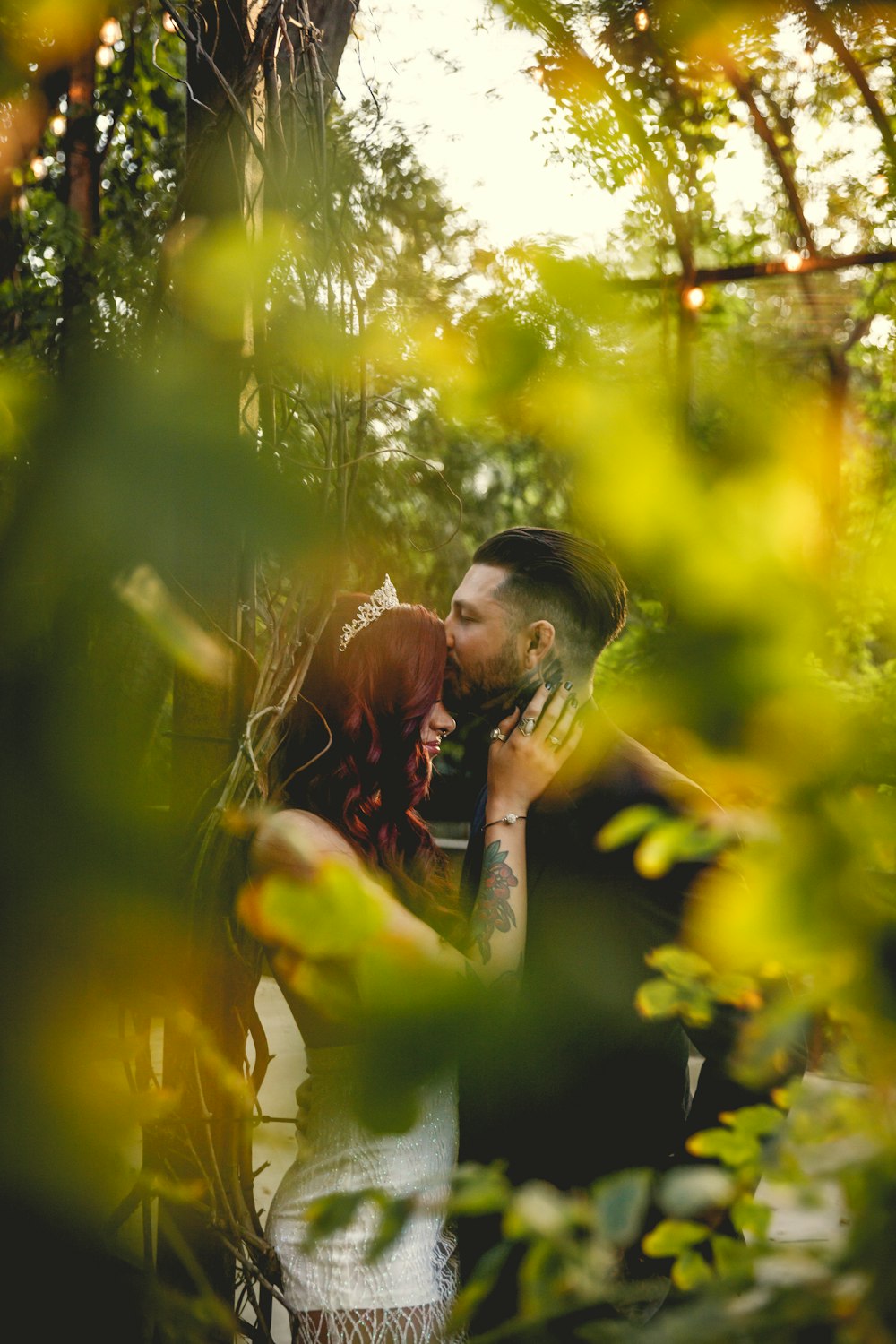 a man and a woman kissing in the woods