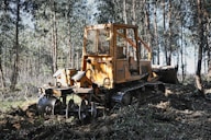 a bulldozer in the middle of a forest